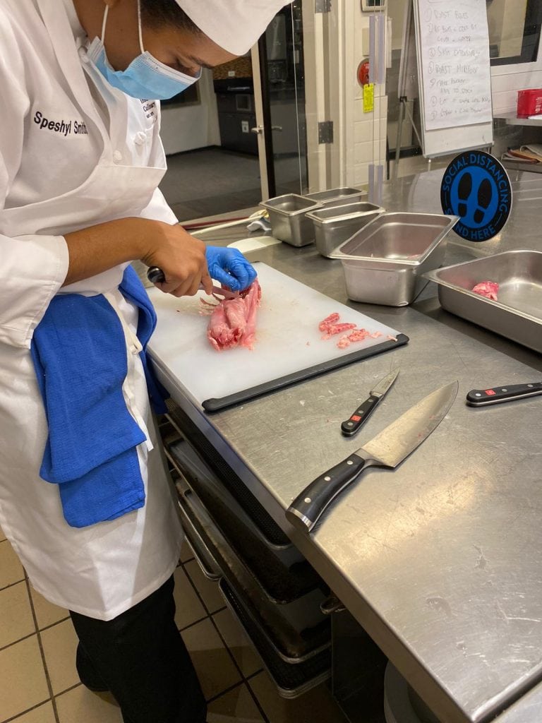 Culinary student completing rabbit fabrication.