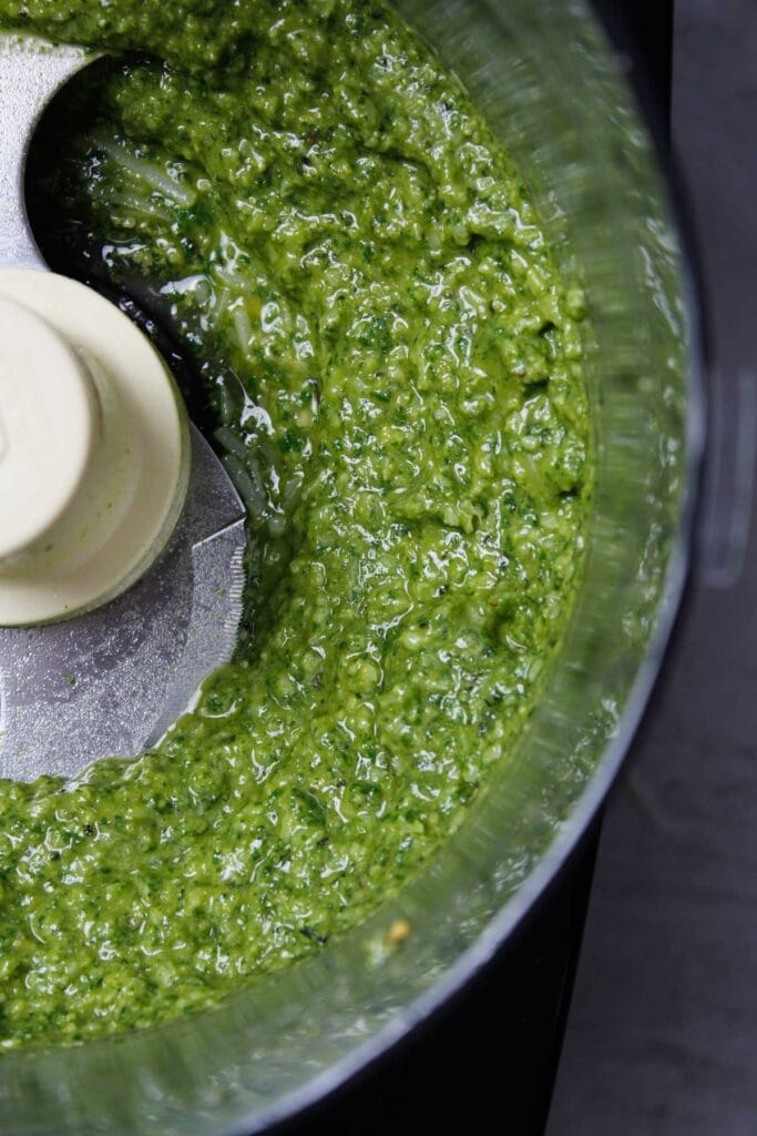 Homemade basil pesto sauce in a food processor.