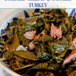 Collard greens with smoked turkey necks in a blue bowl.