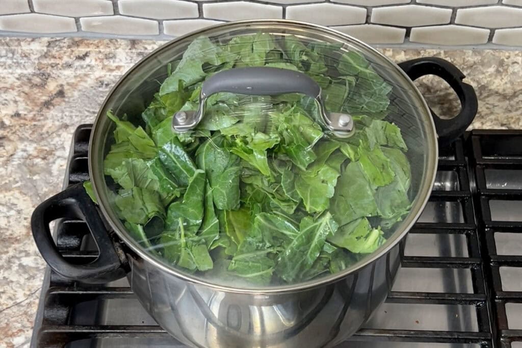 Collard Greens in a large covered pot with smoked turkey.