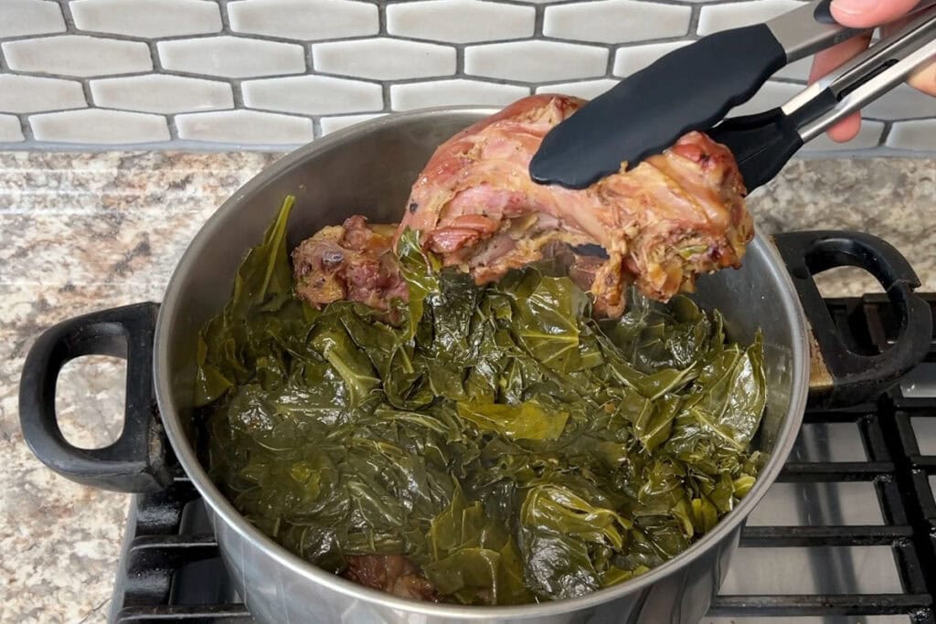 Removing smoked turkey necks from collard greens.