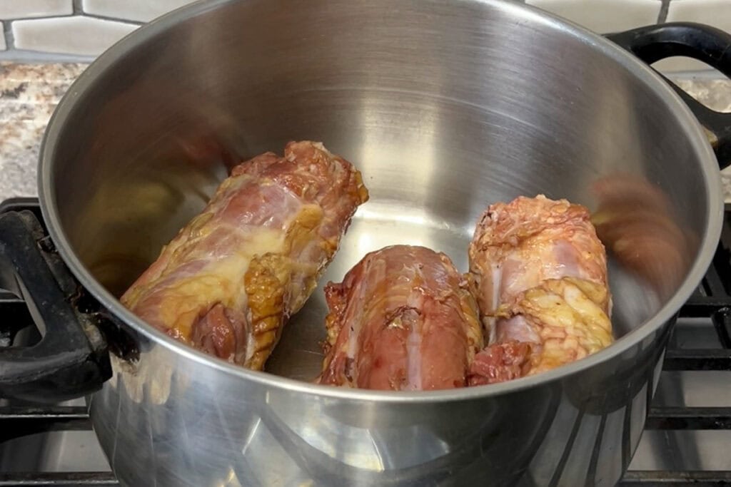 Three turkey necks in a large pot.