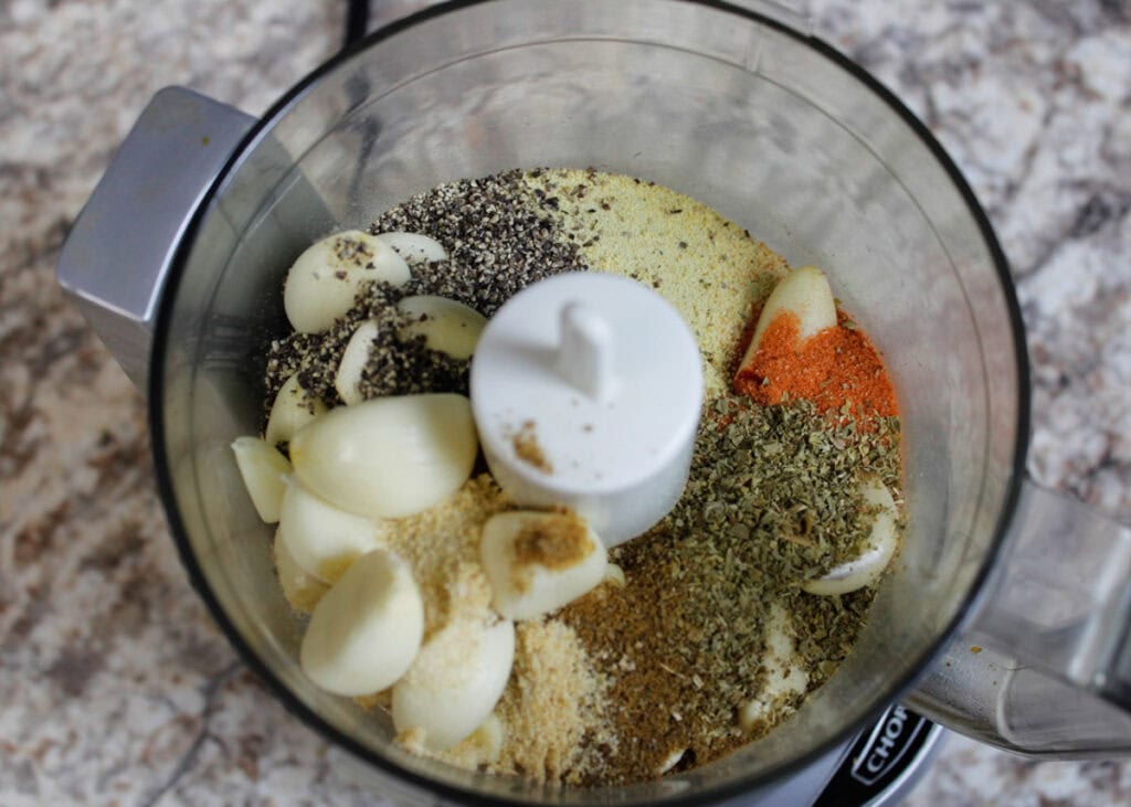 Ingredients for the pernil's garlic marinade in a small food processor.