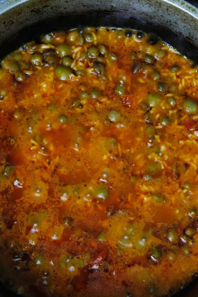 Bringing arroz con gandules to a boil.