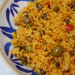 Arroz con gandules in a blue and white plate.