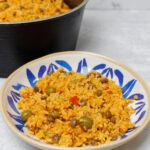 Arroz con gandules in a blue and white plate.