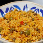 Arroz con gandules in a blue and white plate.