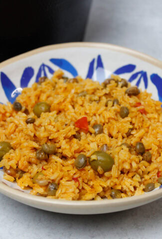 Arroz con gandules in a blue and white plate.