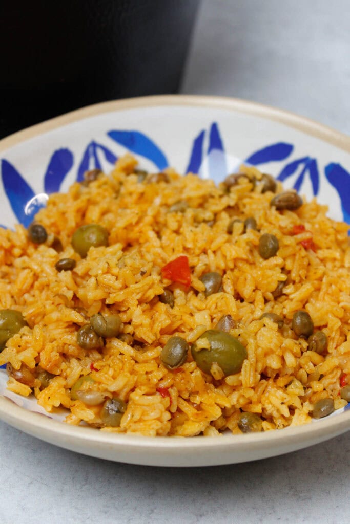 Arroz con gandules in a blue and white plate.