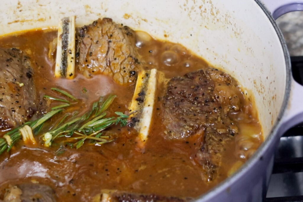 Bringing short ribs to a boil.