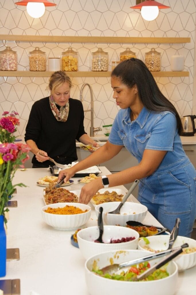Chef Speshyl plating entrees for a networking dinner event.