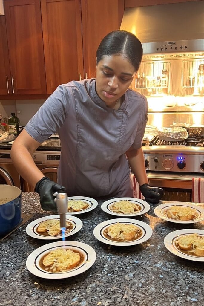 Chef Speshyl plating dinner party soups in a clients home for their dinner party.