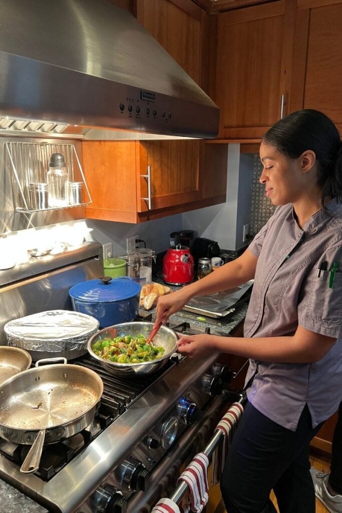 Chef Speshyl preparing brussels sprouts in a clients home for their dinner party.